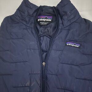 A women’s Patagonia puffer jacket in true navy blue, size medium